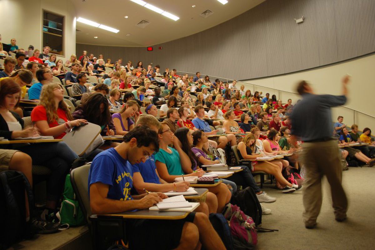 Students in a large lecture hall listening to a faculty member at Iowa State University